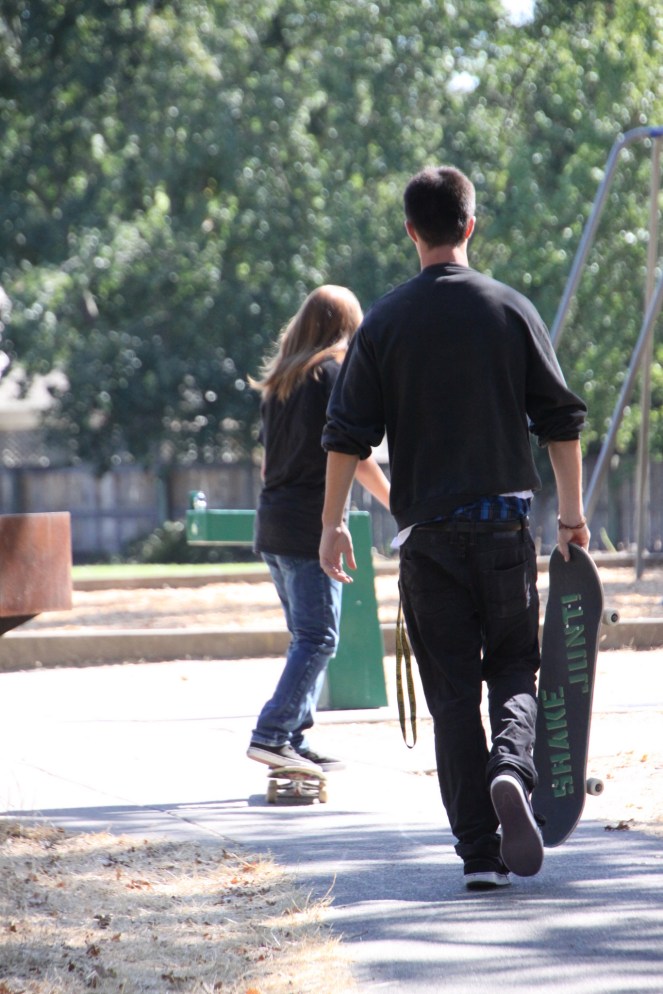 Boys going back towards swing with boards